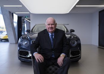 Sir Colin Giltrap sitting in front of Bentley