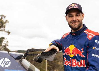 Shane Van Gisbergen standing next to Skoda rally car