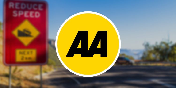 AA logo in front of reduce speed road sign