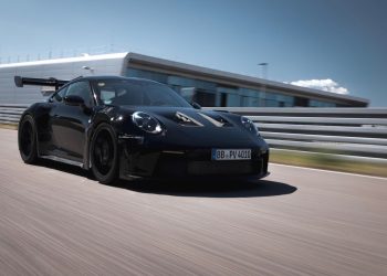 Porsche 911 992 GT3 RS driving on track front three quarters