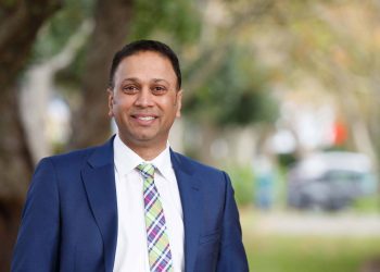 Toyota New Zealand CEO Neeraj Lala standing in front of trees