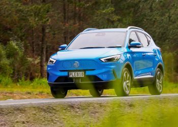 MG ZS driving on road next to trees