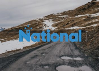 National logo over road with potholes