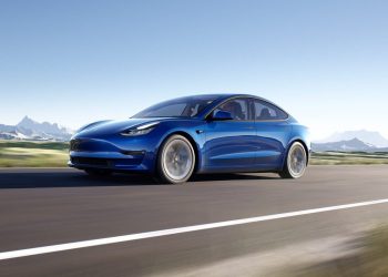 Tesla Model 3 front three quarter view driving