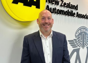 Johnathan Sergel standing in front of AA New Zealand sign