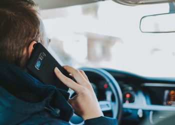 Man using phone while driving