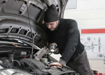 Mechanic inspecting car engine