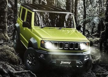 Five-door Suzuki Jimny driving through forest