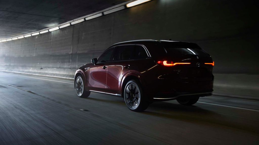 Mazda CX-90 driving through tunnel rear view