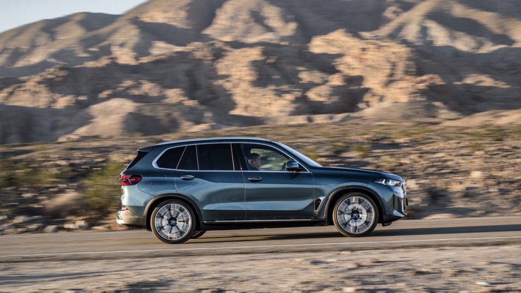 2024 BMW X5 driving through mountain range