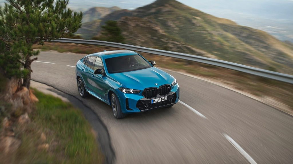 2024 BMW X6 driving around corner