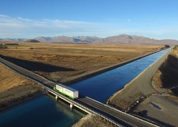 Truck driving over bridge