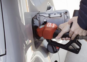 Person filling car up with fuel