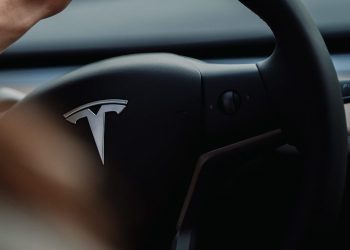 Person holding Tesla steering wheel