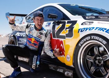 Mad Mike Whiddett posing next to Mazda3 Pikes Peak car