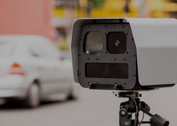 Speed camera pointing at cars on road