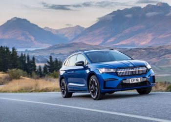 Skoda Enyaq Sportline Launch Edition driving along road next to mountains at sunset