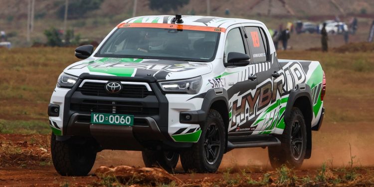 Toyota Hilux hybrid driving on dirt road in Africa