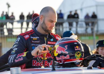 Shane van Gisbergen standing with race helmet