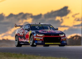 Shane van Gisbergn racing Chevrolet Camaro Supercar in Sydney during sunset