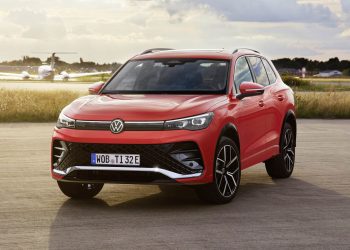 2024 Volkswagen Tiguan parked next to plane