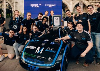 Team of students posing next to muc022 EV distance record holder