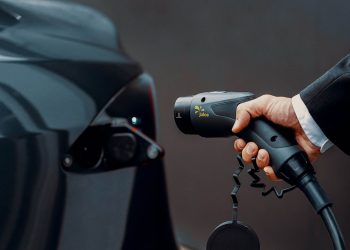 Man holding electric car charging plug