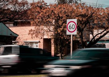 Car driving past speed limit sign