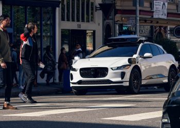 Waymo Jaguar I-Pace driverless taxi stopped at pedestrian crossing