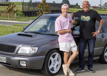 Liam Lawson standing with Mike King next to Subaru Forester charity project car