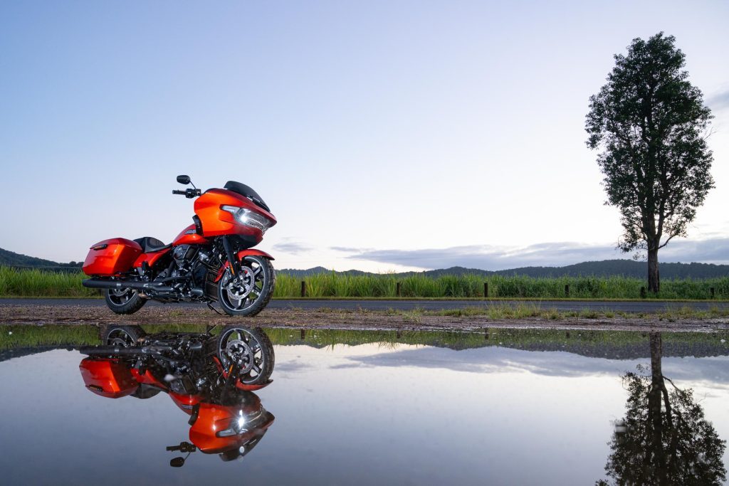 Harley Davidson Road Glide in orange, in a reflection