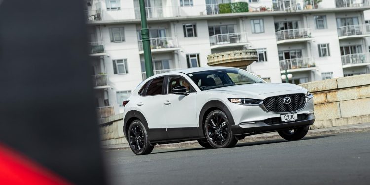 Mazda CX-30 SP25 action cornering shot, in Auckland CBD