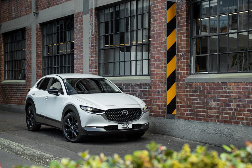 Mazda CX-30 SP25 front quarter shot, with brick wall behind