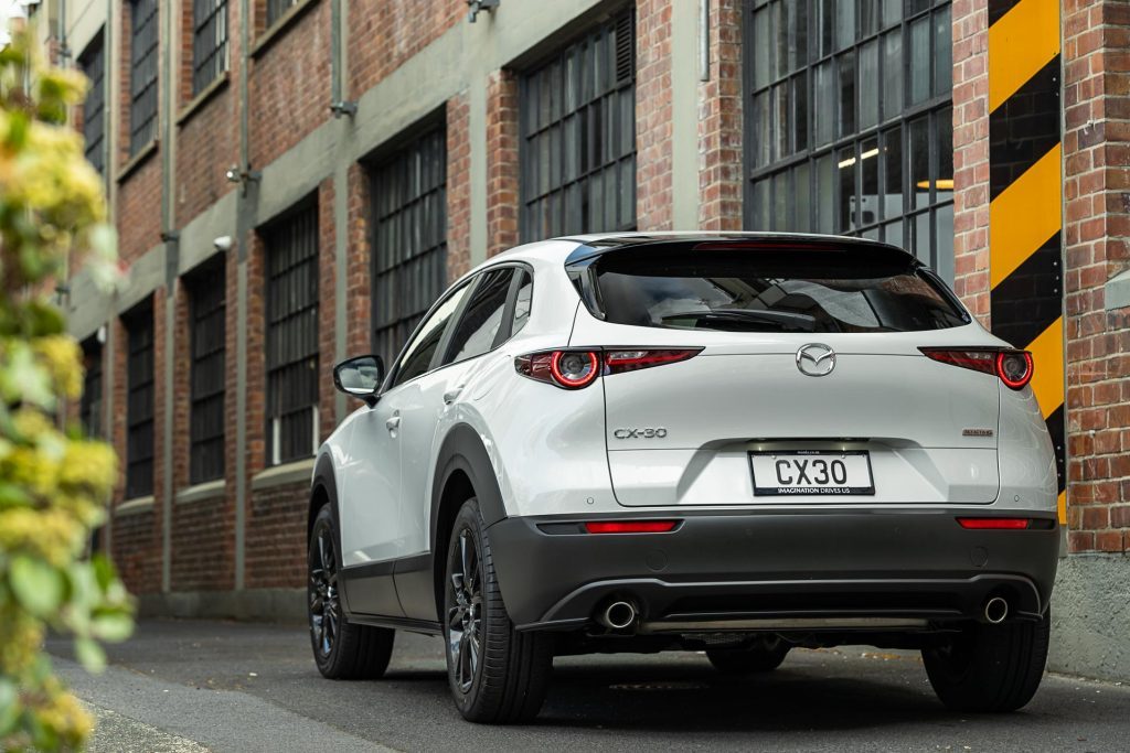 Mazda CX-30 SP25 rear view, in front of brick wall