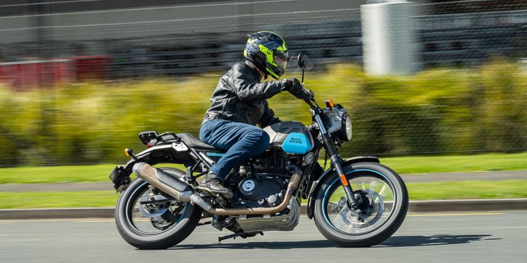 Royal Enfield Scram 411 leaning into a corner, panning shot