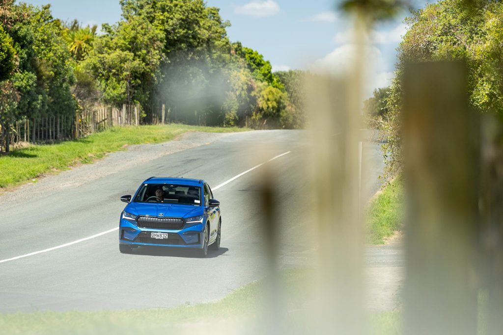 Skoda Enyaq Sportline 80 in blue, driving down the road