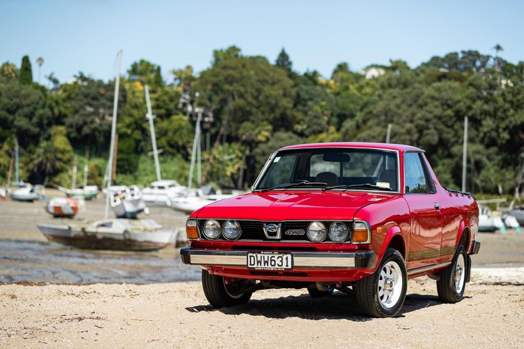 Front quarter detail of the Subaru Brumby in red, on sand