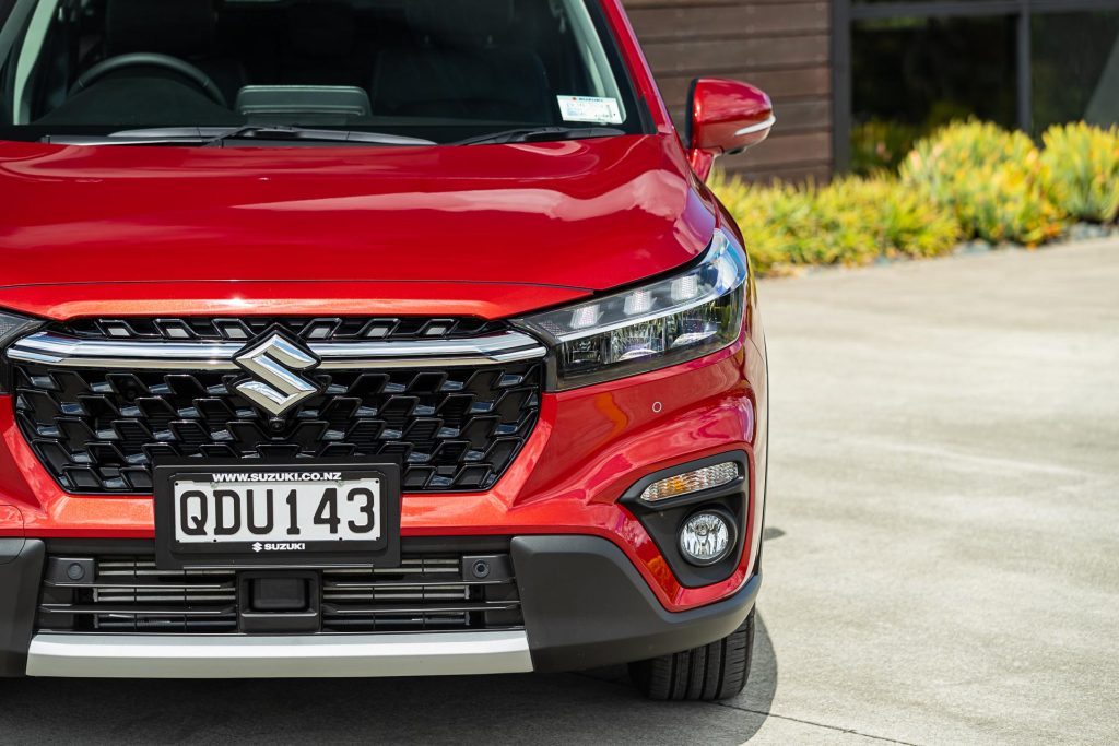 Suzuki S-Cross Hybrid JLX 2WD in red, front headlight profile and detail shot