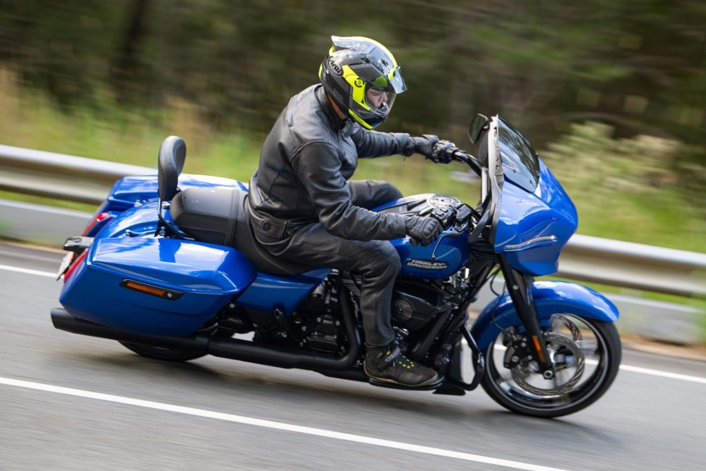 Harley-Davidson Road Street Glide in blue taking a corner, side panning shot