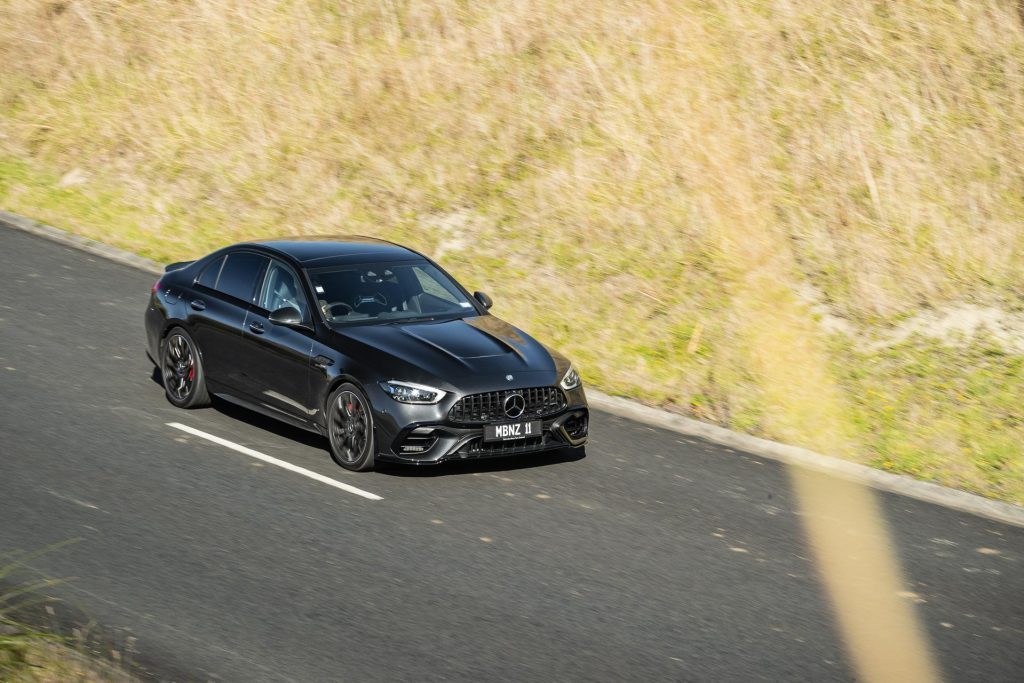 Vantage point view of the 2024 Mercedes-AMG C 63 E Performance  driving past