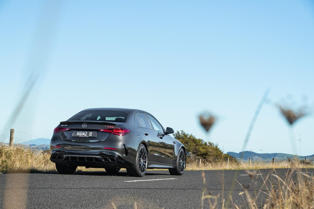 Rear end of the 2024 Mercedes-AMG C 63 S, parked on a backroad