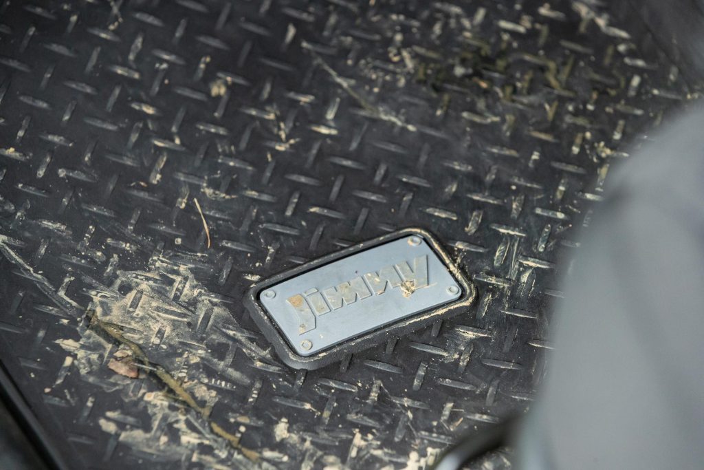 Jimny badge on a rubber floormat