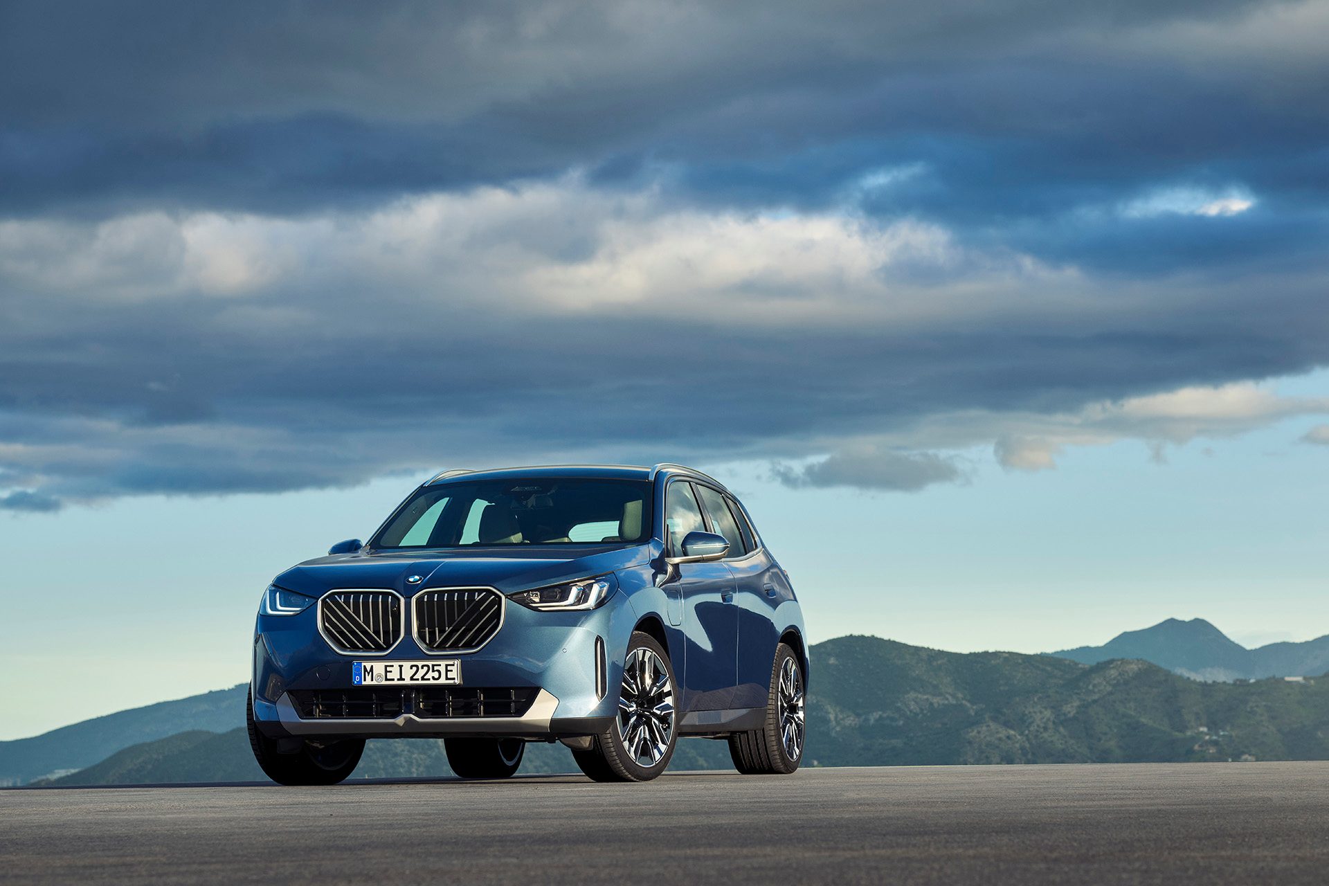 BMW X3 upshot with mountains behind.