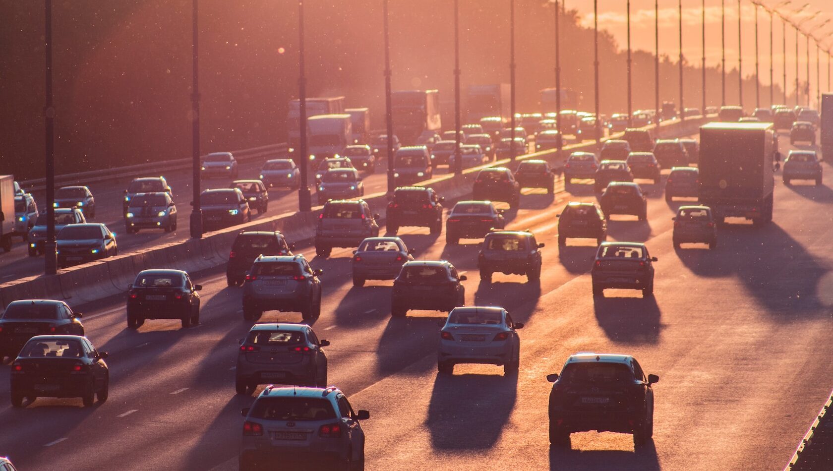 Smog from non-electric vehicles evident in big city motorway shot.