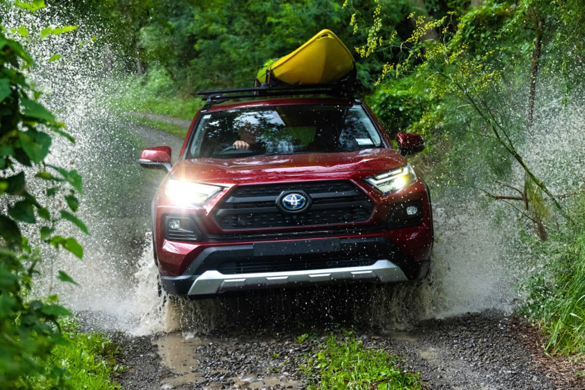 RAV4 hybrid in action fording a water crossing.