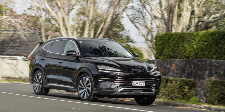 BYD Sealion 6 Dynamic hybrid SUV, taking a corner, in black