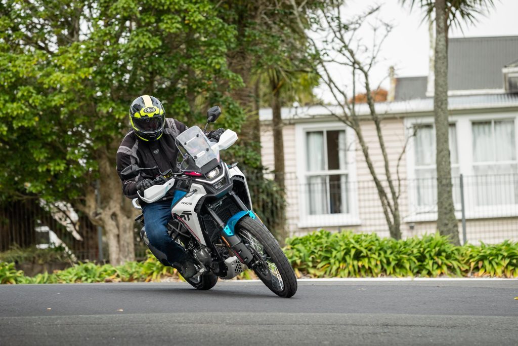 CFMoto 450MT cornering, leaning in around a bend