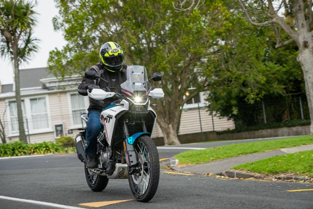 CFMoto 450MT front view, riding in a suburban area