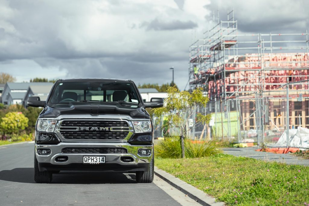 Ram 1500 Big Horn front profile, parked next to a construction zone