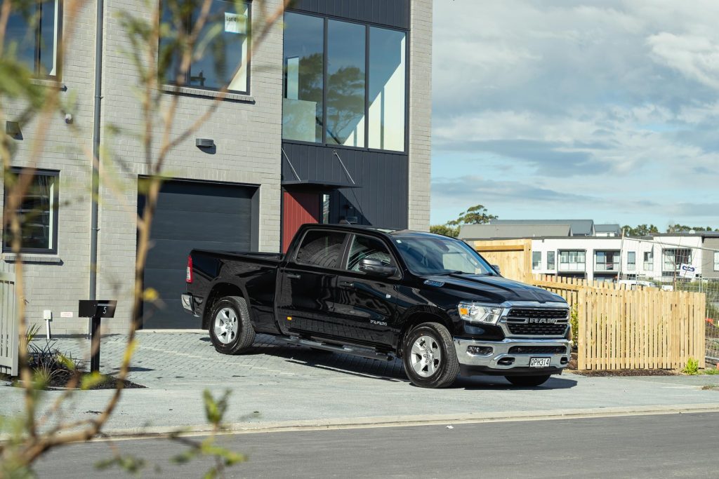 Ram 1500 Big Horn parked in a newly built house's driveway.